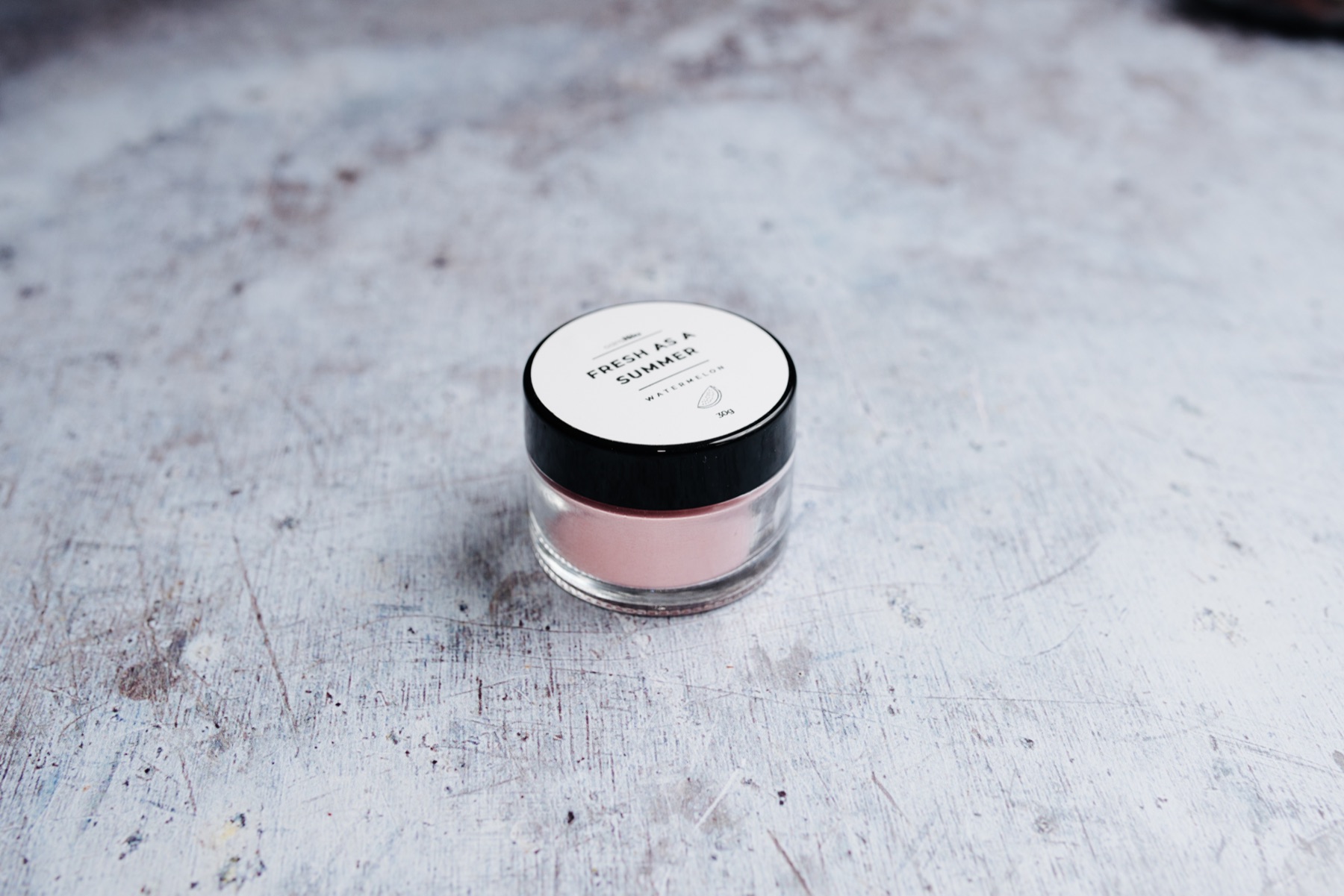 Beauty product arranged on a textured surface